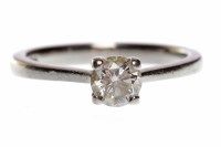 Lot 726 - PLATINUM DIAMOND SOLITAIRE RING with a four...