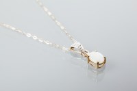 Lot 1902 - OPAL AND DIAMOND PENDANT with an oval cabochon...