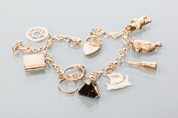 Lot 1906 - NINE CARAT GOLD CHARM BRACELET with charms...