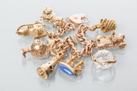 Lot 1910 - NINE CARAT GOLD CHARM BRACELET with charms...