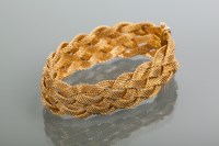 Lot 1911 - FINE EIGHTEEN CARAT GOLD BRACELET of stranded...