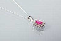 Lot 1962 - RUBY AND DIAMOND CLUSTER PENDANT ON A CHAIN...