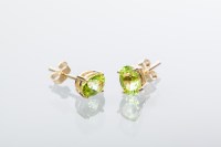 Lot 1971 - PAIR OF PERIDOT STUD EARRINGS each set with an...