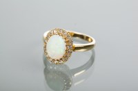 Lot 1985 - OPAL AND DIAMOND CLUSTER RING with a central...