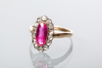 Lot 2024 - RUBY AND DIAMOND CLUSTER RING with a central...
