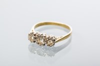 Lot 2036 - DIAMOND THREE STONE RING set with three...