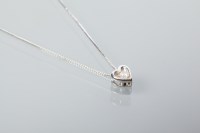 Lot 2058 - DIAMOND SET HEART PENDANT set centrally with a...