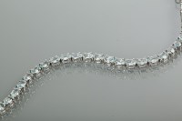 Lot 2139 - AQUAMARINE TENNIS BRACELET set with oval cut...