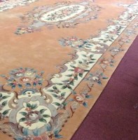Lot 427 - LARGE CHINESE CARPET with peach ground, 740cm...