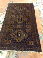 Lot 428 - AFGHAN RUG with indigo field, 202cm long,...