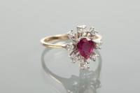 Lot 1101 - RUBY AND DIAMOND CLUSTER RING the central pear...