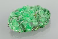 Lot 1116 - ART DECO CARVED JADE BROOCH of oval form,...