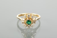 Lot 1139 - EMERALD AND DIAMOND CLUSTER RING set with a...
