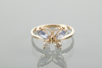 Lot 1141 - TANZANITE AND DIAMOND RING the bezel in the...