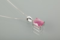 Lot 1143 - RUBY PENDANT set with a faceted pink ruby of...