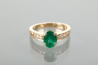 Lot 1144 - EMERALD AND DIAMOND DRESS RING with a central...