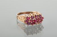 Lot 1154 - LATE TWENTIETH RUBY DRESS RING with three rows...