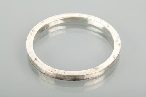 Lot 1161 - CHARLES HORNER SILVER BANGLE of circular form,...