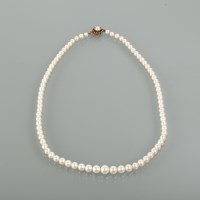 Lot 1168 - MID TWENTIETH CENTURY GRADUATED PEARL NECKLACE...