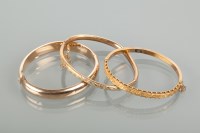 Lot 1170 - TWO VICTORIAN BANGLES one with foliate motif...