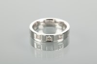 Lot 1179 - DIAMOND SET BAND set with three brilliant cut...