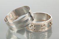 Lot 1202 - TWO VICTORIAN SILVER BANGLES one with overlaid...