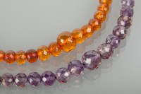 Lot 1219 - AMETHYST BEAD NECKLACE AND AN AMBER BEAD...
