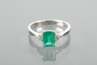 Lot 1221 - EMERALD AND DIAMOND RING set with a central...