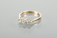 Lot 1239 - DIAMOND THREE STONE RING the three brilliant...
