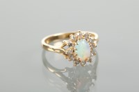 Lot 1240 - OPAL AND DIAMOND CLUSTER RING set with a...