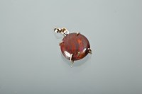 Lot 1275 - OPAL PENDANT the round stone of brown-red...