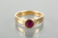 Lot 1282 - LATE TWENTIETH CENTURY RUBY RING set with a...