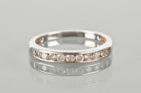 Lot 1287 - DIAMOND HALF ETERNITY RING channel set with...
