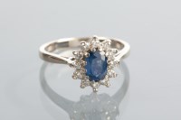 Lot 1289 - SAPPHIRE AND DIAMOND CLUSTER RING with a...