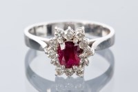 Lot 1660 - RUBY AND DIAMOND CLUSTER RING the central oval...
