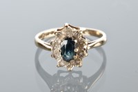 Lot 1735 - SAPPHIRE AND DIAMOND CLUSTER RING with a...