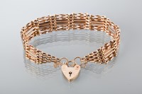 Lot 1744 - NINE CARAT GOLD GATE LINK BRACELET with a...