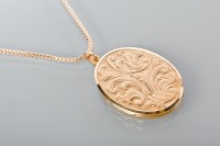 Lot 1751 - NINE CARAT GOLD LOCKET of oval form, with a...