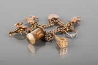 Lot 1762 - NINE CARAT GOLD CHARM BRACELET with charms...
