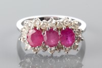 Lot 1764 - RUBY AND DIAMOND CLUSTER RING with three oval...