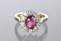 Lot 1770 - RUBY AND DIAMOND CLUSTER RING with a central...