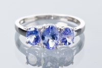 Lot 1803 - TANZANITE THREE STONE RING set with three...