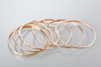 Lot 1811 - GROUP OF NINE CARAT GOLD BANGLES 29.5g gross
