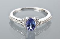 Lot 1812 - TANZANITE AND WHITE GEM SET RING set with an...