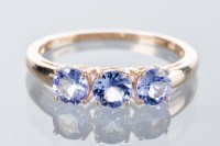 Lot 1814 - TANZANITE THREE STONE RING set with three oval...