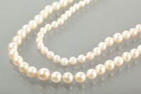 Lot 1695 - TWO PEARL NECKLACES one with a fifteen carat...