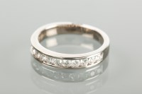 Lot 1700 - DIAMOND SET BAND with a row of channel set...