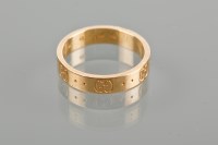 Lot 1753 - EIGHTEEN CARAT GOLD GUCCI RING with Gucci symbols