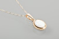 Lot 1760 - OPAL PENDANT with an oval cabochon cut opal,...