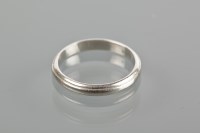 Lot 1799 - PLATINUM BAND of rounded form, with indented...